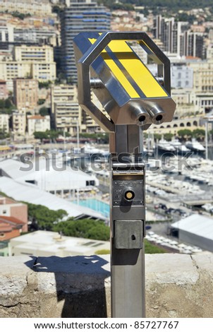 Touristic binocular in yellow. Optical instrument to magnify panoramic views