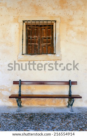 Old bench and window on the streets of Burgo de Osma, Soria, Spain