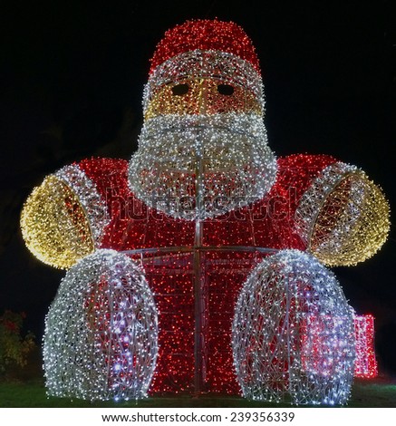 Xmas illumination in a garden with a Santa Claus figure