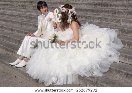 PARIS, FRANCE - SEPTEMBER, 15: Asian groom and bride on September,15 2014. One of the most wanted cities on the world to celebrate weddings for asian people is Paris