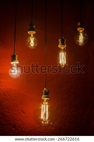 old incandescent lamps lighting together on a wall. Electrical incandescent bulb was a Thomas Alva Edison invention