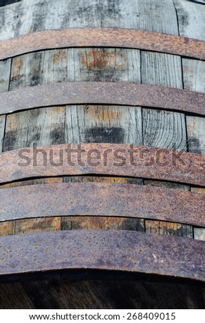 Detail of an old wine barrel made in wood and metal