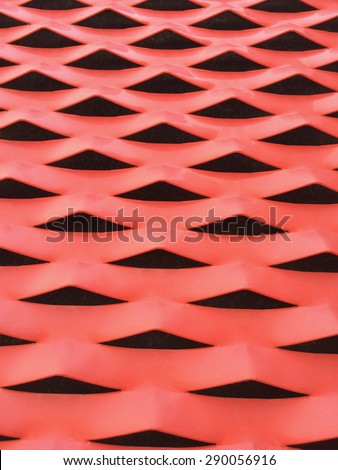 Textured metallic plate painted in red. Abstract vertical background