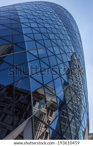 CENTRAL LONDON / ENGLAND - 18.05.2014 - Sky-scraper reflections are seen in the Gherkin's windows.