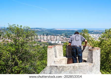 SINTRA, PORTUGAL / Circa May 2014 - Unknown man is admiring the landscape from atop of a tower in the Pena palace in Sintra