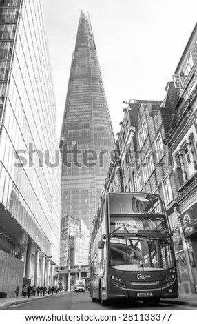 LONDON, UK / 07.03.2015 - Black & white wide shot of London bus in front of The Shard sky scraper
