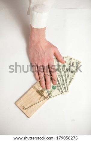 Closeup shot of men hand got caught in mouse trap while he was stealing money