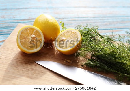 Preparing food for sauce salad by ingredient is lemon and coriander on wood block