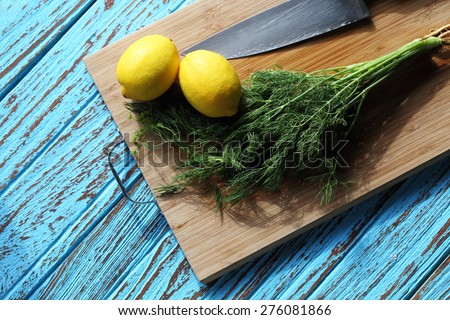 Preparing food for sauce salad by ingredient is lemon and coriander on wood block