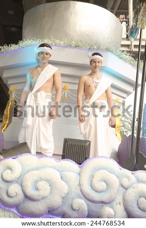 Bangkok, Thailand - January 14, 2015: Group of Thai traditional dressed people over moving stage near Pathumwan intersection \