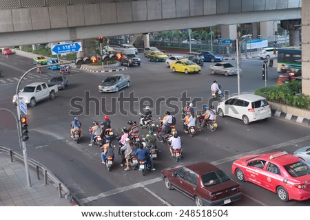 Bangkok, Thailand - January 30, 2015 :  Various vehicles break law by stop car beyond the white line on the ground during red light. This is typical behavior of people when traffic police is not strict