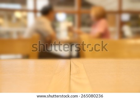 Abstract blurry bright dessert restaurant with unrecognizable blurry couple eating