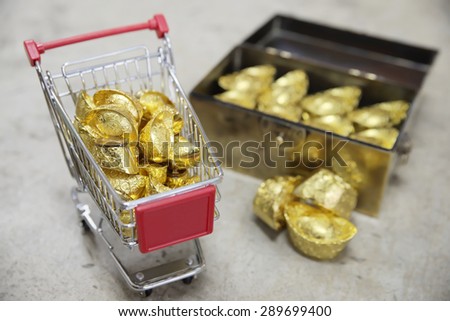 Abstract shallow DOF of pushcart fully load with chineses word blessed gold for good fortune, best of luck, and good health