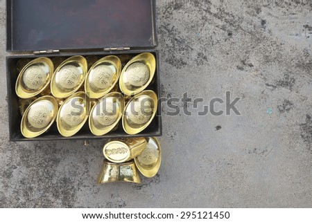 Abstract shallow DOF of chest full of gold with craved chinese words for good fortune, best of luck, and good health