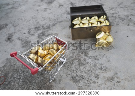 Abstract shallow DOF of gold transferring from treasure chest by pushcart with chinese word crafted on gold for good fortune, best of luck, and good health