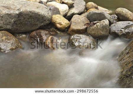 Closeup of water flow over rocks inside Wang Takai Water fall, Nakhorn nayok distrinct