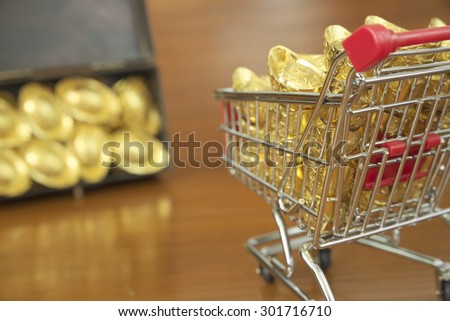 Abstract closeup concept of gold treasuring into treasure chest by pushcart. The chinese words are crafted into gold with meaning of good fortune, best of luck, and good health.