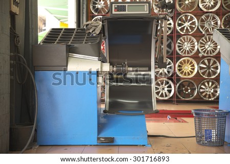 Empty old wheel balancing machine inside rim shop