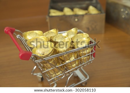 Concept of gold treasuring into treasure chest by pushcart. The chinese words are crafted into gold with meaning of good fortune, best of luck, and good health.