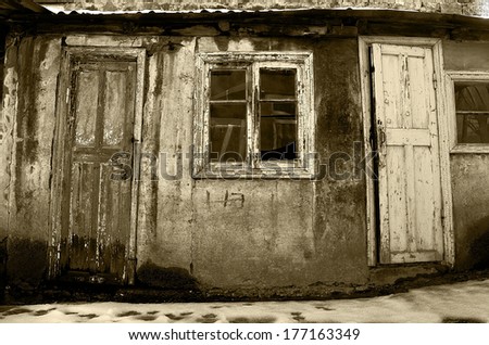 Abandoned facade with wood windows and doors