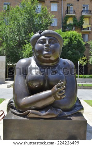 YEREVAN, ARMENIA -  JUNE 30, 2014: Modern art statue near Yerevan Cascade, a bronze statue of a naked woman and a thick.One of the most important sights in Yerevan completed in 1980