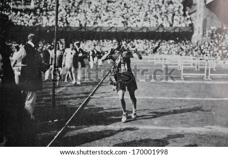 STOCKHOLM - 1912: Reproduction of old photography of runner Mac Arthur from South Africa winning marathon at Olympic Games in Stockholm, 1912