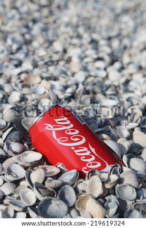 NETHERLANDS - SEPTEMBER 25, 2014: Coca-Cola can on the beach.