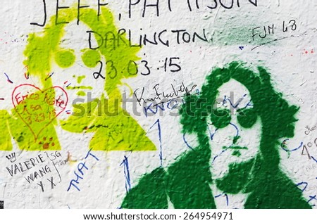 PRAGUE, CZECH REPUBLIC - MARCH 24, 2015: The Lennon Wall since the 1980s is filled with John Lennon-inspired graffiti and pieces of lyrics from Beatles songs on March 24, 2015 in Prague.