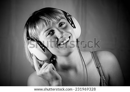 young girl listening to music on headphones. black and white