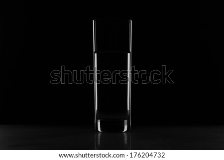 Glass with water in the dark - object in the shadow