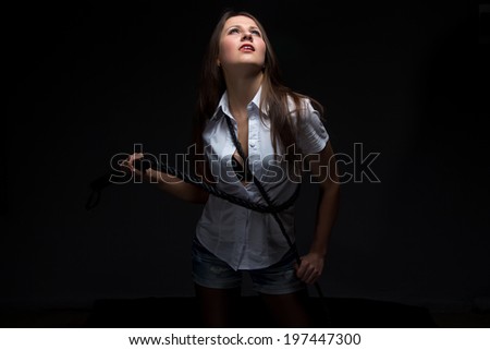 Woman in shadow with whip - isolated photo