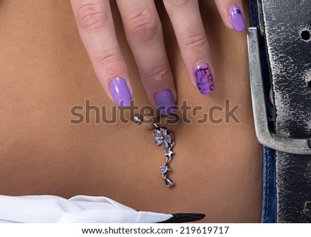 Image of belly and piercing - girl lying on her side