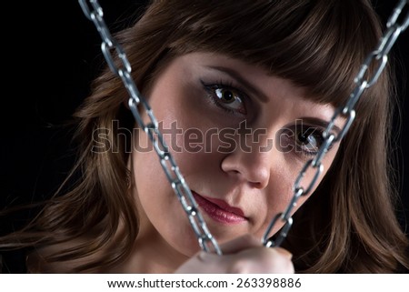 Photo of woman with chains on black background