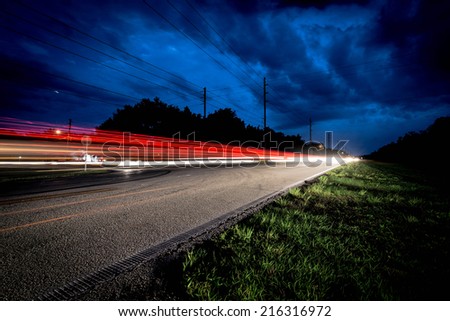 Car Light Trails. A speeding car late at night in Orlando, Florida, USA