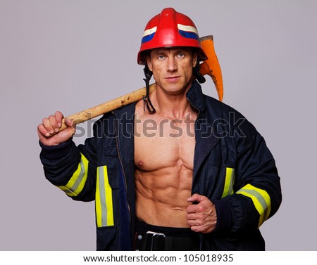 Portrait of fireman on grey background