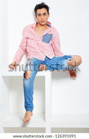 Fashionable and sweet guy portrait over a grey background