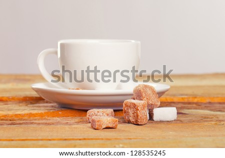 Composition of coffee cup and pieces of sugar