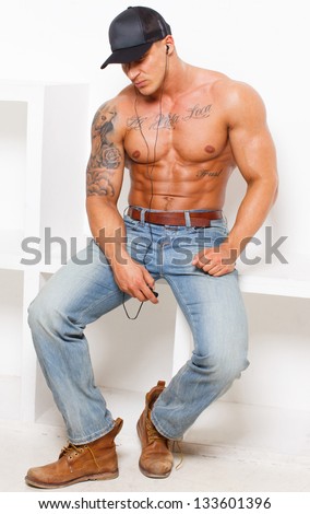 Image of hot guy in jeans who is listening music