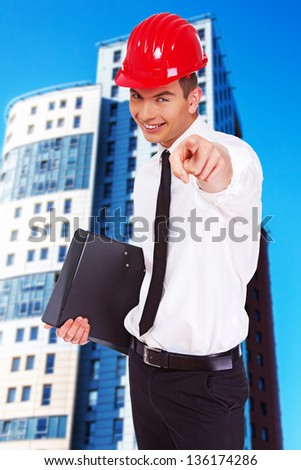 Image of happy businessman who is pointing on someone with his finger