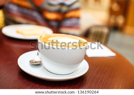 Image of coffee cup with some drawing on it