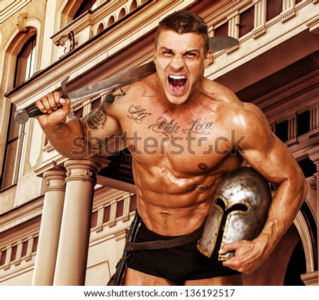 Image of huge hot warrior who is holding his sword and helmet and screaming
