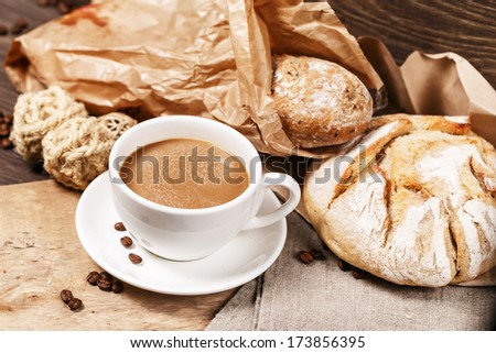 Cafe au lait and loaves of bread in a paper bag