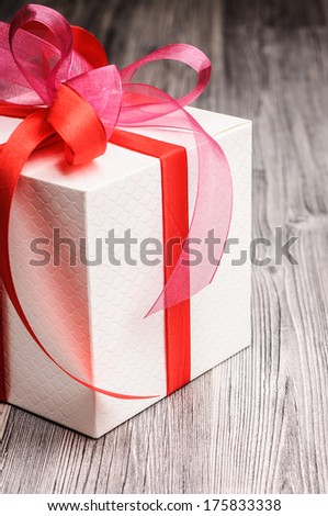 White festive box with red ribbons