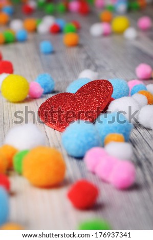 A heart and scattered felt beads