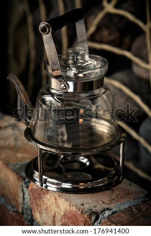 A glass teapot on a gas stove