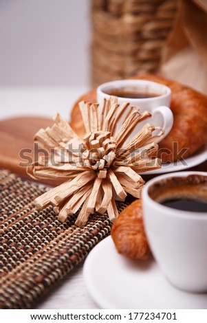Handmade flower and coffee with croissants
