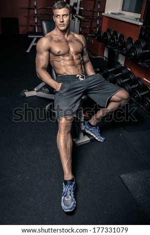 Fit guy sitting in a gym