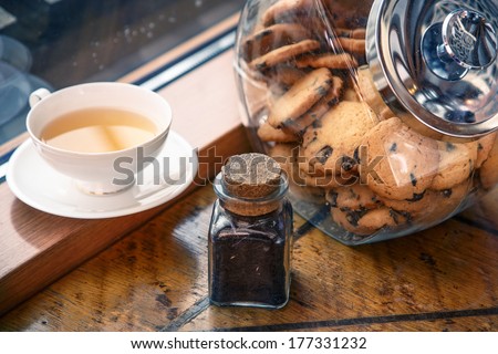 A cup of tea and cookies by the window