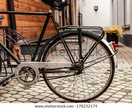 An old bicycle parked in a town center