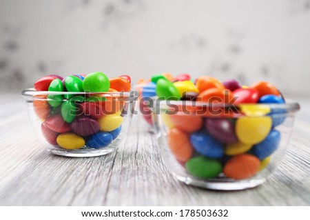 Multicolored candies in transparent bowls
